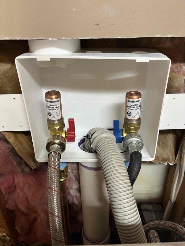 Completed QUOTR repair by raising laundry box to proper height for customer's washing machine connections. Installed new hammer arrestors on both hot and cold water supply lines and ensured proper connection of flexible supply lines and drainage hose. Total service time: 2.5 hours.
