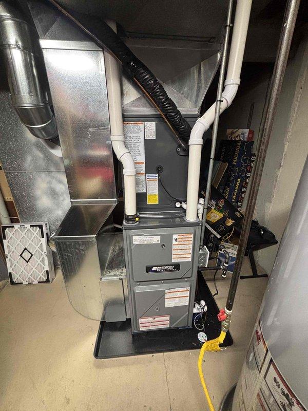 Completed full system replacement with installation of new furnace unit in basement utility area and outdoor air conditioning condenser unit. New system includes proper ductwork connections, PVC venting, condensate drainage, and electrical disconnect box for safe operation. All components were properly installed according to manufacturer specifications and industry standards.