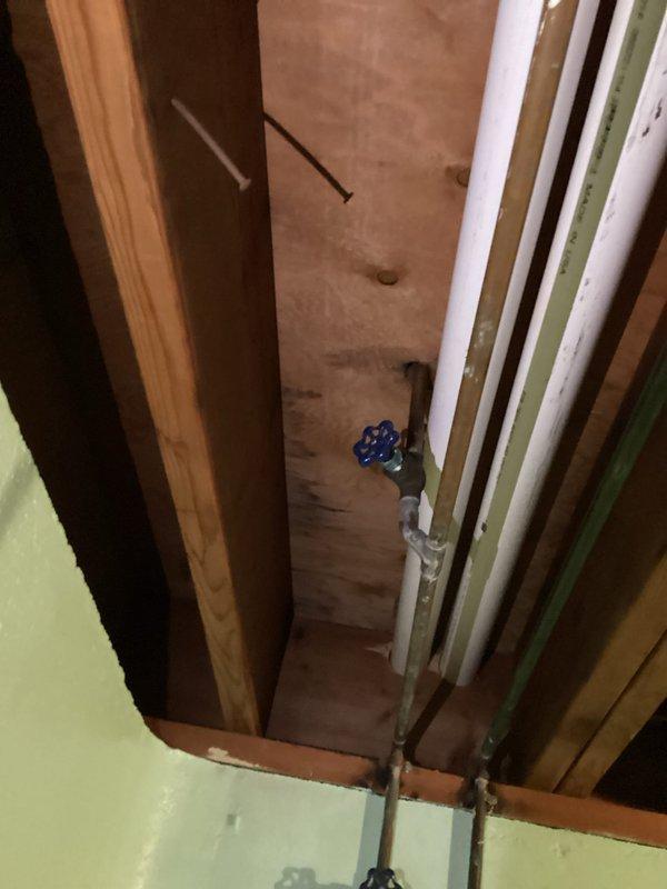 Completed relocation of existing plumbing to accommodate new dishwasher installation in 55-year-old residence. Work involved reconfiguring copper supply lines and modifying drain pipe positioning within wall cavity. Installed new shut-off valve for improved accessibility and ensured all connections were properly secured to structural framing.
