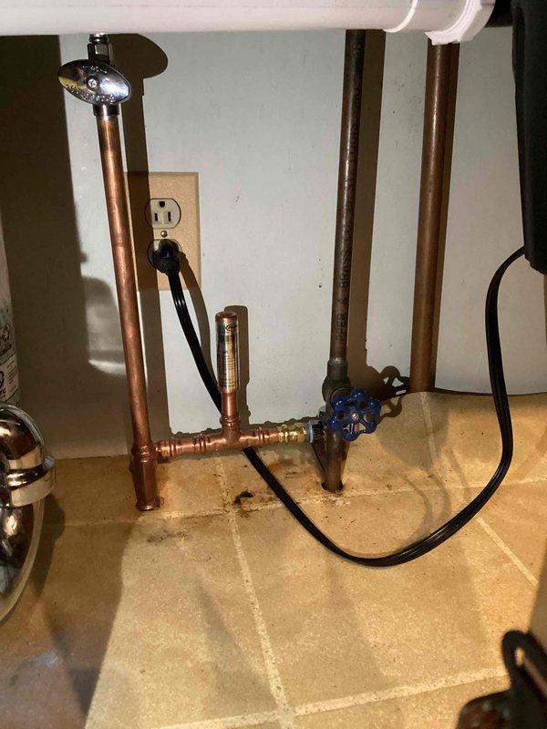 Completed relocation of existing plumbing to accommodate new dishwasher installation in 55-year-old residence. Work involved reconfiguring copper supply lines and modifying drain pipe positioning within wall cavity. Installed new shut-off valve for improved accessibility and ensured all connections were properly secured to structural framing.
