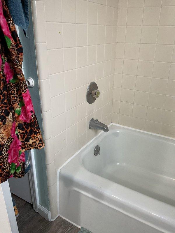 Successfully completed bathtub faucet repair service by installing customer-provided replacement parts to resolve leakage issue. Inspected and tested the chrome fixtures including tub spout, shower control handle, and shower head mounting plate to ensure proper functionality and no further leaks.