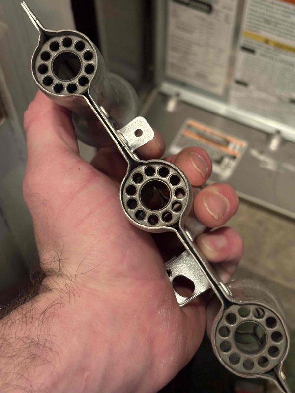 Performed annual heating tune-up on residential furnace, arriving within scheduled window. Inspected system components using Allen wrench and examined burner assembly with multiple ports. No issues detected with the heating system; noted customer does not have humidifier despite being on service club.