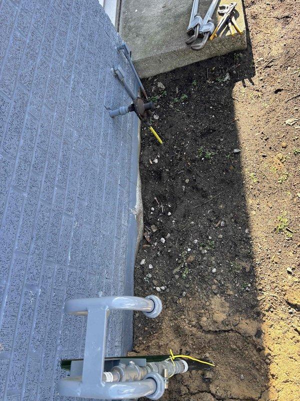 Successfully completed CONV-LP to NG conversion with no complications. Accessed property through unlocked door while unoccupied and documented installation with photos showing the exterior connection point and the updated plumbing components attached to the structure.