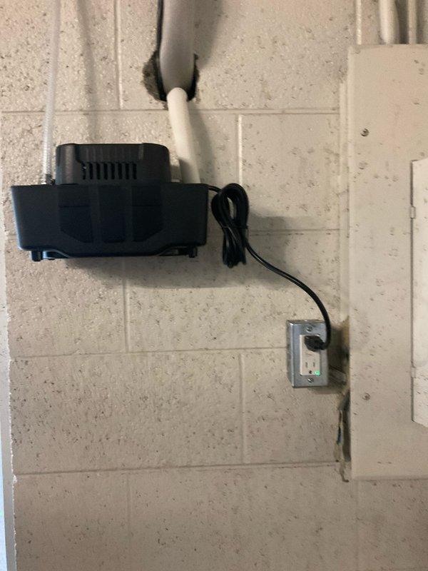 Successfully completed installation of a mini-split system, including mounting the condensate pump on the concrete block wall with proper electrical connection and PVC line penetration. System was fully installed with insulated refrigerant lines and electrical conduit properly routed through the mechanical space, with all components tested and verified operational.