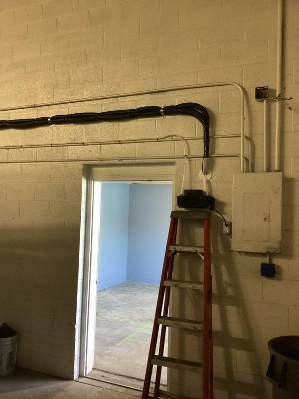 Successfully completed installation of a mini-split system, including mounting the condensate pump on the concrete block wall with proper electrical connection and PVC line penetration. System was fully installed with insulated refrigerant lines and electrical conduit properly routed through the mechanical space, with all components tested and verified operational.