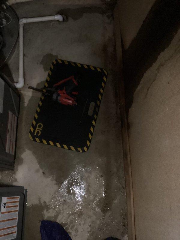 Responded to service call for 9-year-old Amana furnace leaking from bottom. Inspection revealed moisture accumulation on concrete floor near unit with compromised water line connections. Repaired loose fittings on copper supply pipes and replaced damaged section of black foam insulation to resolve the leak.