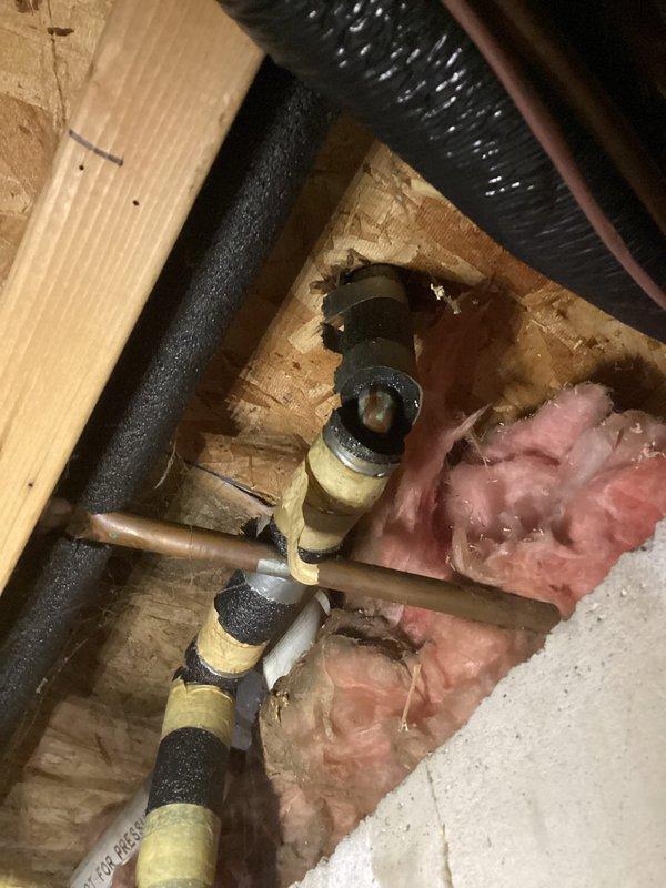 Responded to service call for 9-year-old Amana furnace leaking from bottom. Inspection revealed moisture accumulation on concrete floor near unit with compromised water line connections. Repaired loose fittings on copper supply pipes and replaced damaged section of black foam insulation to resolve the leak.