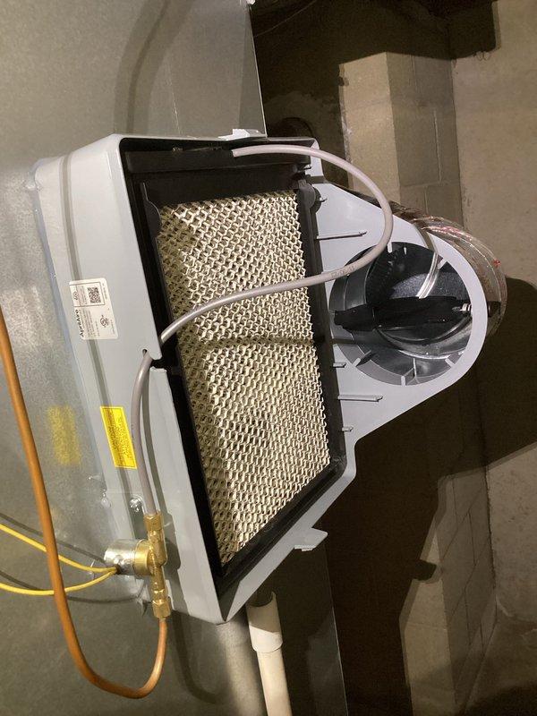 Performed annual maintenance on EnergiAir furnace and humidifier system (model WT 08-2034). Inspected and photographed the humidifier unit, confirming proper installation of the evaporative water panel and verifying integrity of water supply connections including PVC and copper tubing. System is functioning within normal parameters.