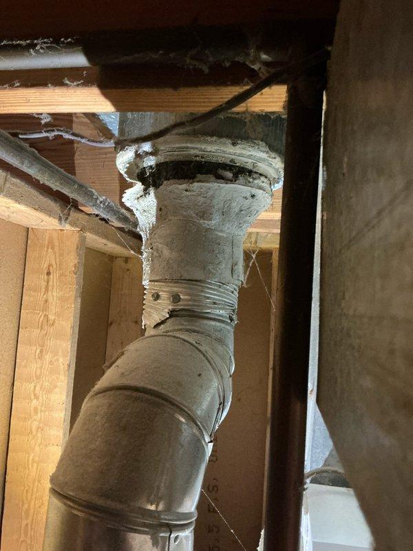 Completed furnace estimate for 16-year-old unit replacement. Inspected existing ductwork and ventilation system, noting aged metal piping with insulation and visible cobwebs in the framing structure. Documented galvanized ductwork condition and PVC venting configuration for proper system sizing and installation requirements.