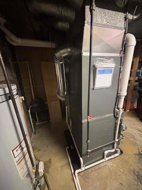 Successfully installed new furnace and air conditioning system in basement utility area. System includes properly connected white PVC ventilation ducts and all required ductwork. Michigan Saves financing paperwork completed and submitted through DocuSign.