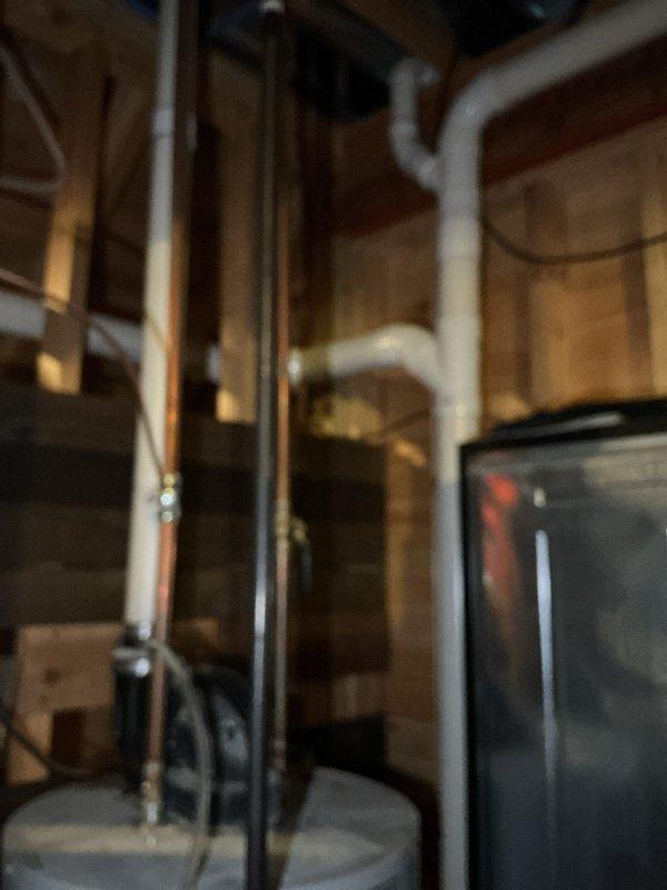 Conducted comprehensive water heater replacement estimate in residential basement. Inspected existing plumbing infrastructure including copper and PVC piping configurations. Documented current installation with photos showing utility area layout and connection points for proper sizing and installation requirements of new unit. Provided quote to customer for complete water heater replacement service.