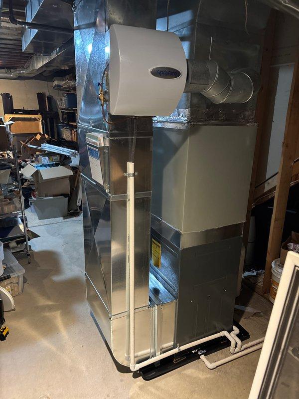 Successfully completed furnace replacement with installation of new Ameristar furnace unit with integrated Aprilaire humidifier system. Installed complete ductwork connections, PVC venting, and condensate drainage lines in unfinished basement area. System was properly mounted on platform base, all connections were verified, and unit was tested for proper operation.
