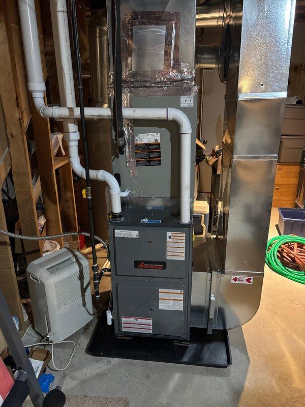 Successfully completed furnace replacement with installation of new Ameristar furnace unit with integrated Aprilaire humidifier system. Installed complete ductwork connections, PVC venting, and condensate drainage lines in unfinished basement area. System was properly mounted on platform base, all connections were verified, and unit was tested for proper operation.