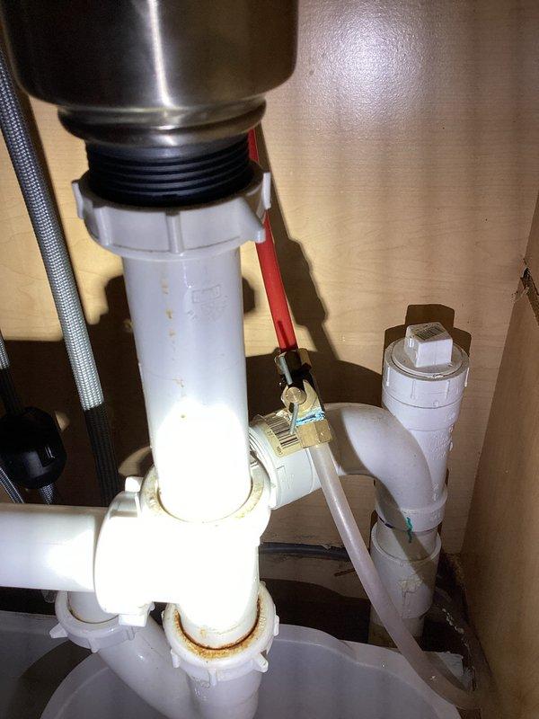 Completed third service call for sink leak following previous installation. Identified connection issue at drain assembly where the rubber gasket meets the PVC drainage system. Repaired leak by properly reseating the gasket and tightening all connections in the P-trap configuration, ensuring proper water flow without further leakage.