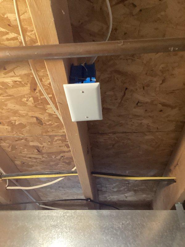 Inspected electrical panel and junction box per home inspection requirements. Found circuit breaker panel properly installed with labeled circuits for major appliances including sump pump, hot tub, AC, and kitchen circuits. Verified wiring connections in exposed junction box located in unfinished area with OSB panels; all connections appeared secure with no visible damage or deterioration.