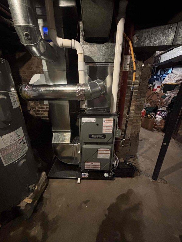 Successfully completed installation of new Amana furnace in basement utility room, properly connecting all necessary ductwork, PVC venting, and ensuring optimal placement alongside existing water heater. System was fully tested and verified operational with proper airflow through the newly installed components.