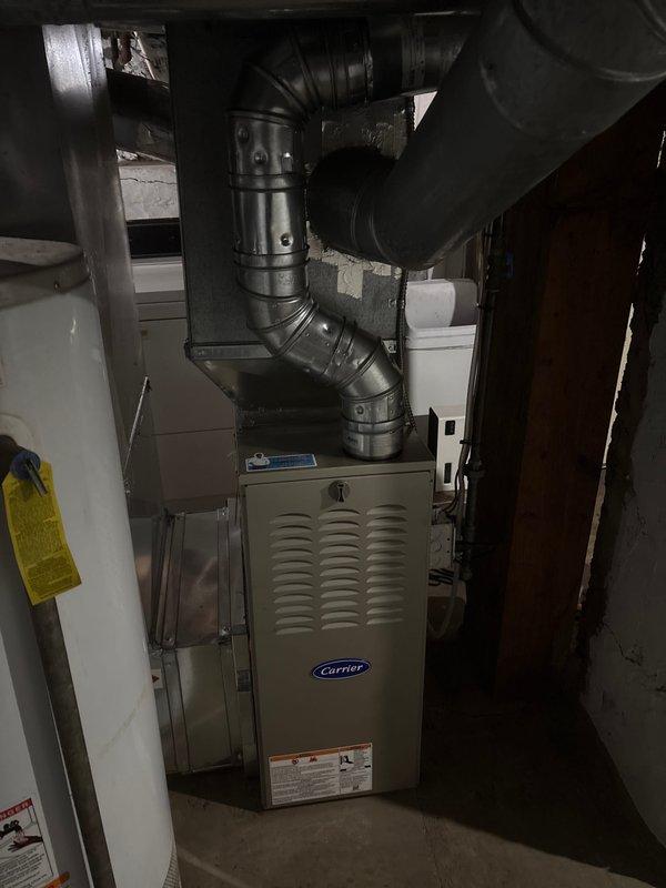 Successfully installed a new Carrier furnace unit in the utility room, complete with proper connection to existing ductwork system. All ventilation components were secured with appropriate metal fasteners, and system was verified to be in normal working condition with no leaks or abnormalities.