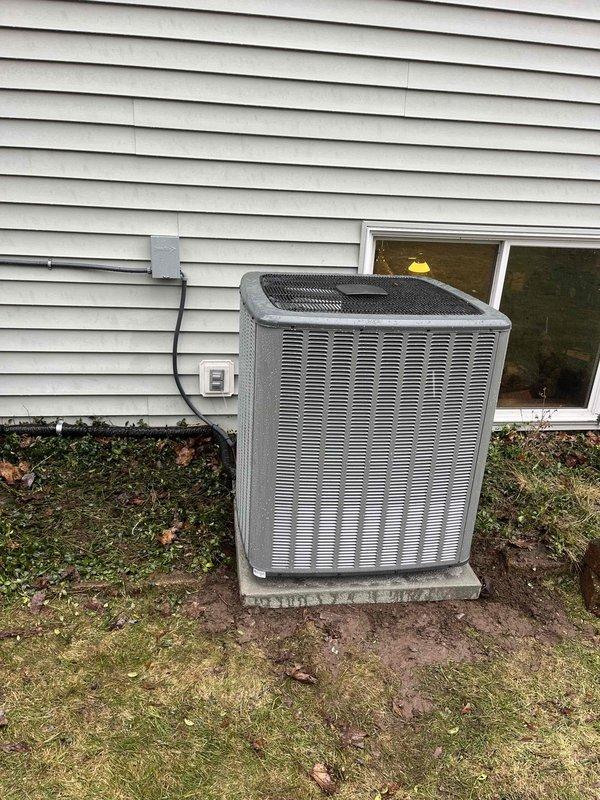 Successfully completed installation of a new furnace system and outdoor AC condenser unit. The furnace installation included an Aprilaire humidifier with proper ductwork connections in the basement utility area, while the outdoor unit was properly mounted on a concrete pad with electrical connections secured to the exterior wall.