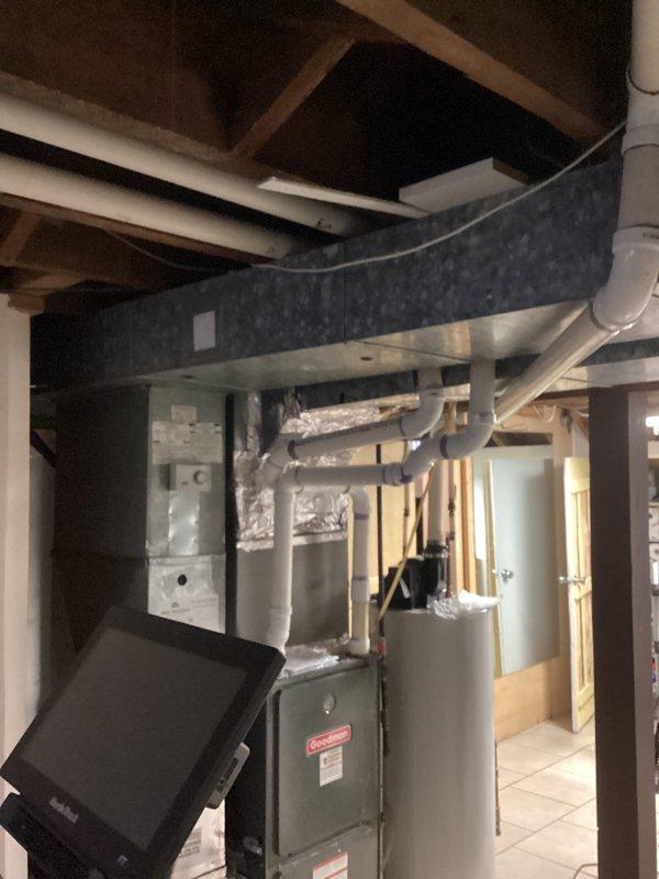 Identified and repaired water leak originating from failed seal on water heater supply pipe connection. Inspected basement floor area affected by slow leak spread, confirmed no damage to surrounding tile flooring, and verified proper function of Defender water heater system after repair.