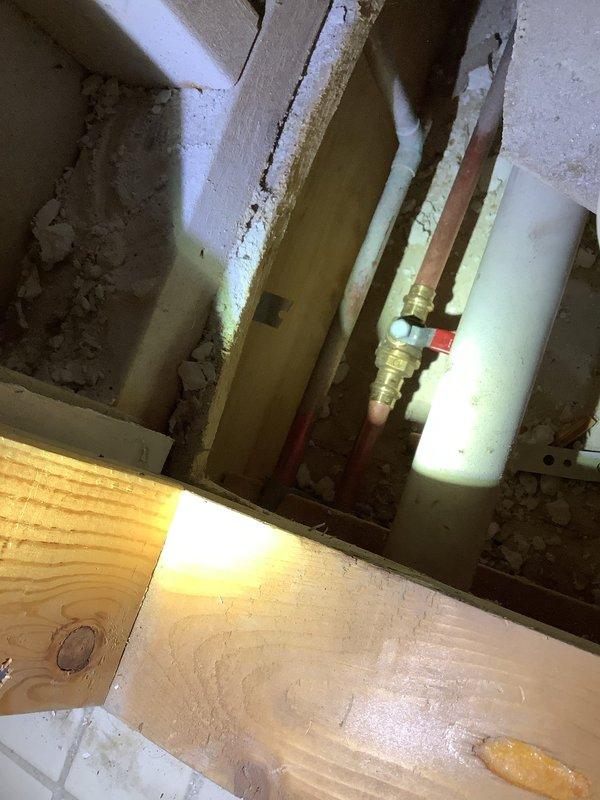 Responded to service call for faucet leak with no separate shut-off valve. Accessed wall cavity to locate main plumbing lines, then used specialized tools to repair the leaking fixture while customer's main water supply remained shut off. Successfully resolved leak issue and restored proper function to bathroom sink faucet.