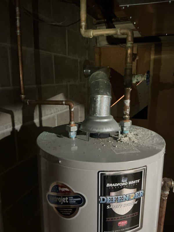 Conducted a water heater estimate for client at their request, inspecting an existing Bradford White unit with Defender Safety System and Microjet technology. Examined the current installation including copper piping, PVC connections, metal vent pipe, and shutoff valves to determine replacement options and requirements for the basement location.