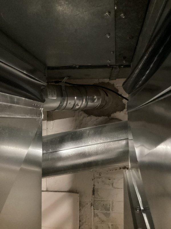 Performed annual heating tune-up on 10+ year old furnace system. Identified significant copper pipe corrosion at floor penetration and inspected ductwork damper assembly. Documented issues with photos for reference and recommended repair of corroded piping to prevent potential leaks.