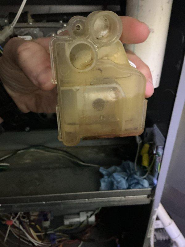 Diagnosed 13-year-old ICP furnace with no heat condition. Physical inspection revealed significant contamination and sediment buildup in the condensate collection system, evidenced by discolored trap components with visible brownish residue. Performed necessary maintenance to restore proper system operation.
