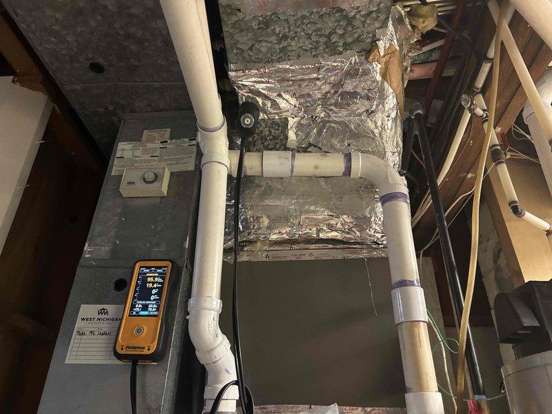 Responded to water leak service call for 18-year-old GDM furnace. Diagnosed leak originating from the exhaust vent connection and collector box. Performed inspection with diagnostic tools to verify issue and documented condition with photos of the HVAC system including PVC ventilation piping and internal furnace components.