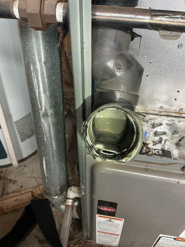 Diagnosed furnace issue where unit was cycling with blower operation but no heat production. Visual inspection revealed deterioration around heat exchanger access port with visible corrosion. Determined failed heat exchanger was the root cause, rendering the aging unit unsafe for continued operation. Customer was advised of findings and replacement options.