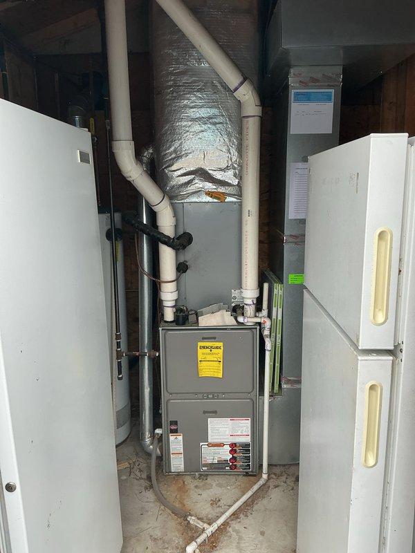 Diagnosed furnace issue where unit was cycling with blower operation but no heat production. Visual inspection revealed deterioration around heat exchanger access port with visible corrosion. Determined failed heat exchanger was the root cause, rendering the aging unit unsafe for continued operation. Customer was advised of findings and replacement options.