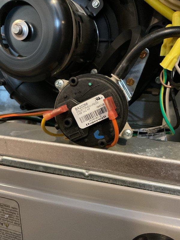 Inspected HVAC system and identified faulty pressure switch as indicated by diagnostic codes. Replaced defective pressure switch and verified proper connection of wiring harness to motor assembly. System now operating within normal parameters with restored heating function.