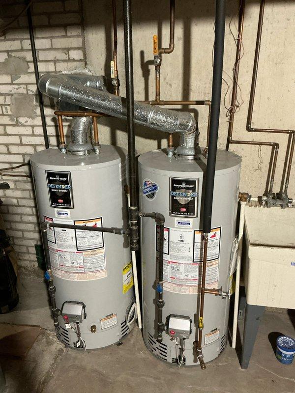 Responded to service call for a non-functioning furnace with blank thermostat. Upon inspection, found thermostat had no batteries installed. Inspected water heater installation and surrounding plumbing infrastructure while on site, noting Bradford White units with proper venting and copper supply lines in good working condition.