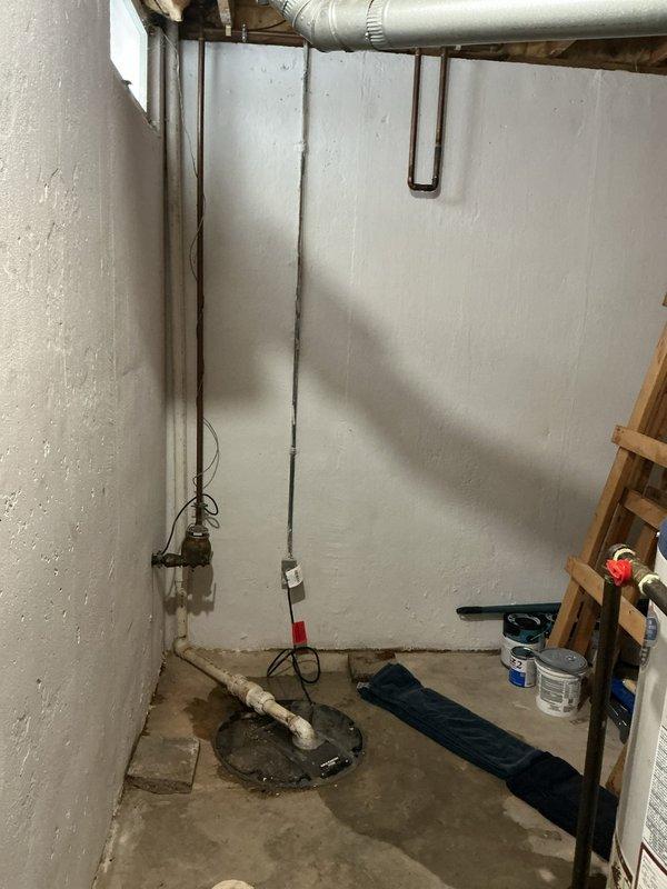 Diagnosed and serviced a non-functioning sump pump in basement. Sump pump was found in a concrete floor pit with PVC discharge piping. Observed moisture staining around pump area, indicating recent water presence, and restored system to proper working condition.