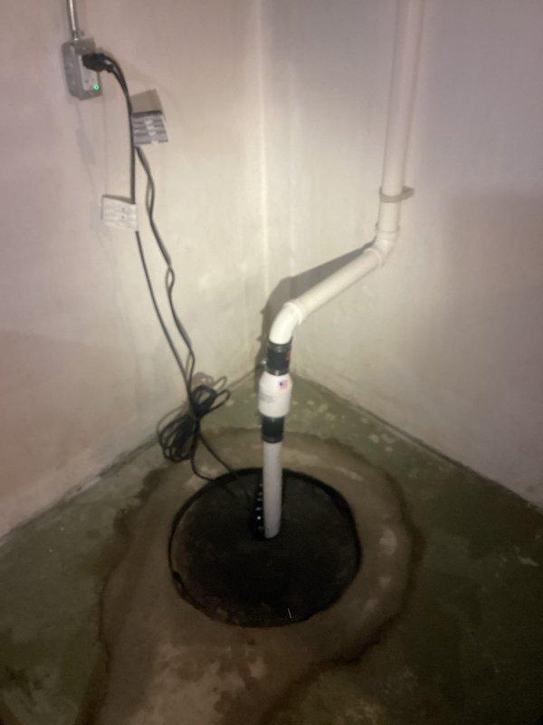 Diagnosed and replaced a non-functioning sump pump in basement where the crock was full and unit was not activating. Installed new pump with proper electrical connections and verified discharge line integrity through the existing PVC piping system. System now operating correctly with proper water evacuation from the sump pit.