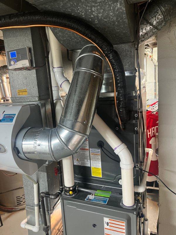 Successfully installed new American Standard HVAC system including indoor air handler unit with complete ductwork integration and PVC condensate drainage. Outdoor condenser unit was properly placed on concrete pad with electrical connections established according to manufacturer specifications.