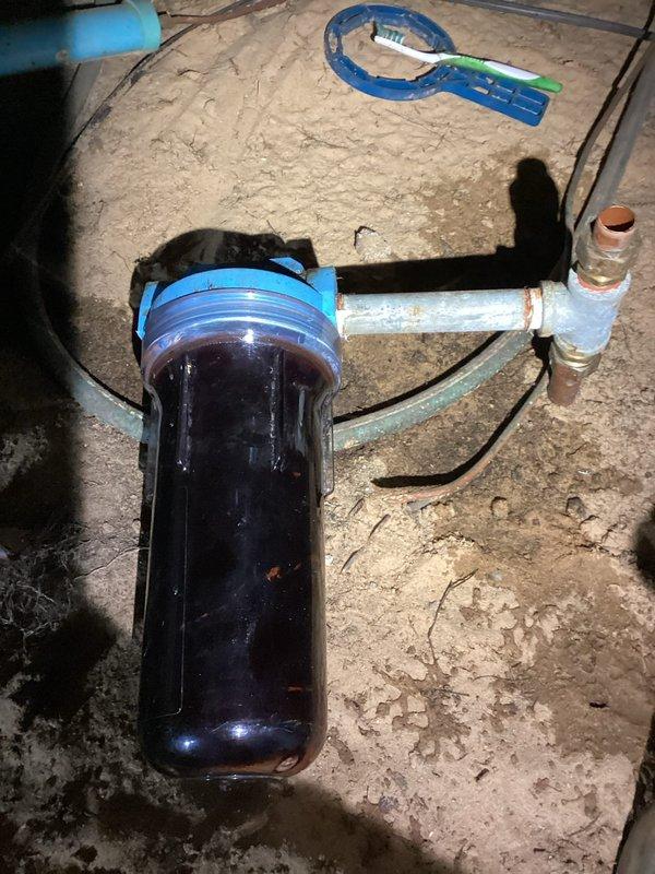 Installed a whole-house water filter system in the crawlspace, connecting it to the existing copper supply line. The clear housing with blue cap was properly mounted and secured to ensure effective filtration of sediment and contaminants from the incoming water supply.
