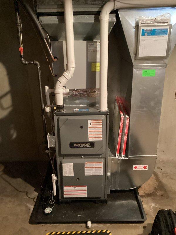 Performed annual heating maintenance on a 2-year-old EnergiAir furnace (model WT 03-2034). System inspection revealed no operational issues. Documented Rheem Professional water heater and complete HVAC system with proper ventilation connections. All components functioning within normal parameters.