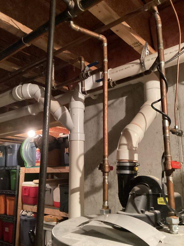 Responded to customer request for water heater estimate after existing unit leaked and was emptied. Conducted visual inspection of current installation, noting copper supply lines, PVC drainage connections, and existing plumbing configuration in basement utility area. Documented current setup with photos to prepare comprehensive replacement estimate.