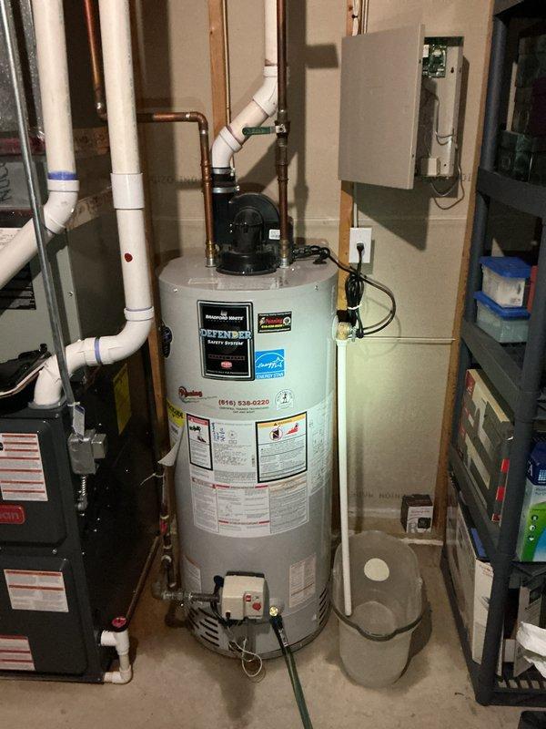 Completed water heater replacement estimate for customer (CWOW). Inspected existing unit in utility room, noting it was approaching end of life with visible wear on connections and tank. Evaluated current plumbing configuration including PVC venting and copper supply lines, and confirmed electrical panel accessibility for potential upgrade. Documented site conditions with photos to provide accurate quote for replacement options.