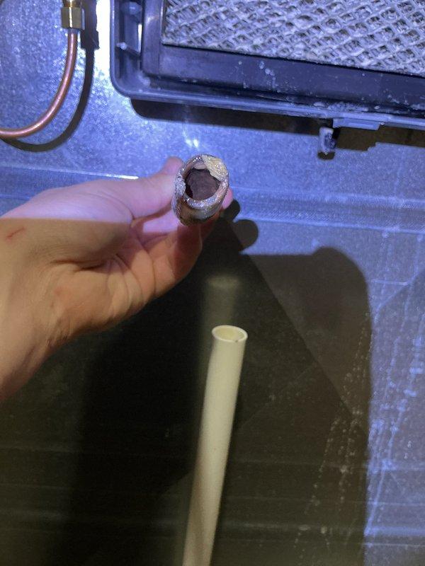 Performed annual heating maintenance on 12-year-old Goodman furnace. Discovered deteriorated condensate drain line with significant internal corrosion and mineral buildup. Replaced damaged section and cleared drainage system to restore proper condensate removal and prevent potential water damage.