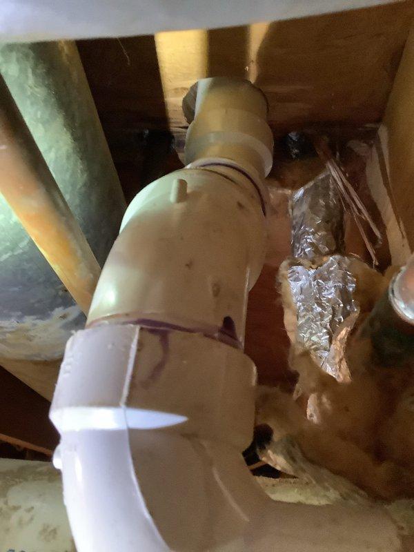 Relocated drain line and water supply for new vanity installation. Completed PVC waste line connections with proper primer/adhesive at joints and installed copper supply lines through existing joist framing. All connections were tested and verified to be leak-free upon completion.