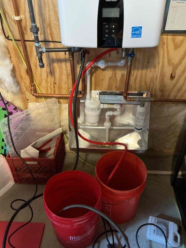 Performed annual maintenance on Navien tankless water heater including complete system flush to remove mineral buildup. Serviced filtration components, checked all connections, and verified proper operation of the unit. System is now functioning optimally with restored efficiency as confirmed by final diagnostic check.