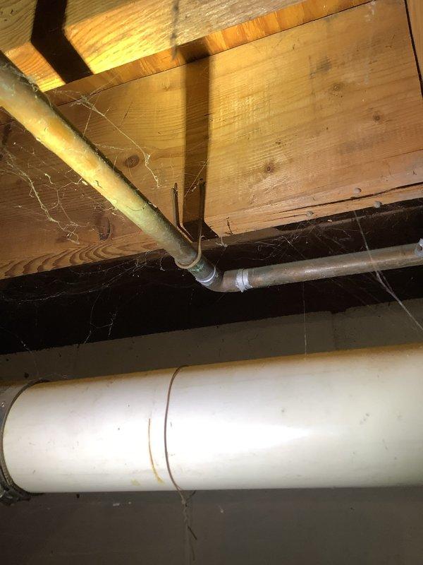 Diagnosed water hammer causing loud pipe banging throughout 1967-built home; identified issues with excessive water pressure and aging pipe infrastructure as evidenced by inspection of basement water treatment system and crawlspace piping. Installed water pressure regulator and water hammer arrestors at key junction points to eliminate noise and prevent potential pipe damage; also performed requested toilet inspection and adjustment.