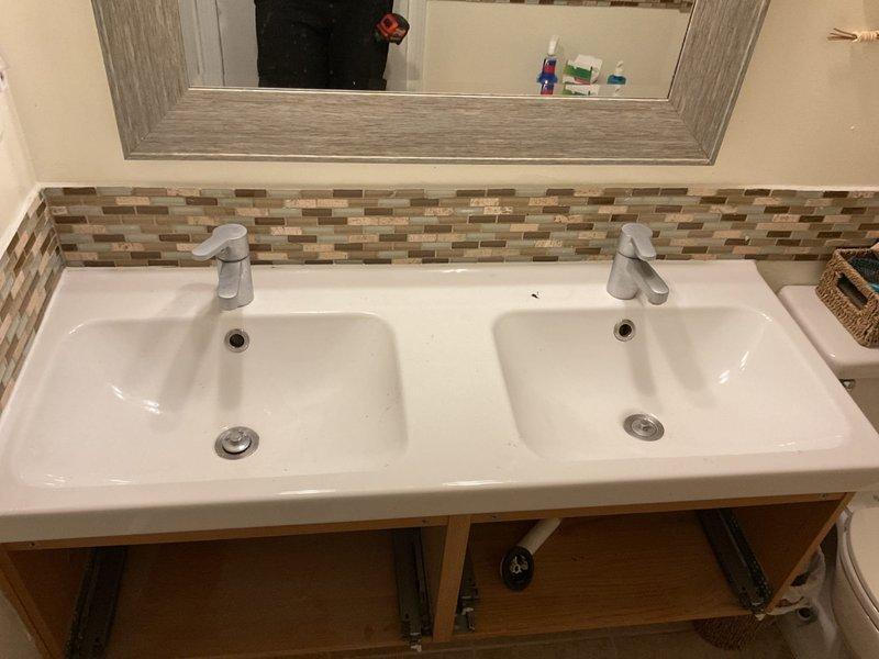 Successfully repaired dual-sink vanity with right faucet leak and left sink slow water flow issues. Disassembled and serviced both faucet assemblies, replacing worn components and clearing mineral buildup to restore proper water pressure and eliminate leakage.