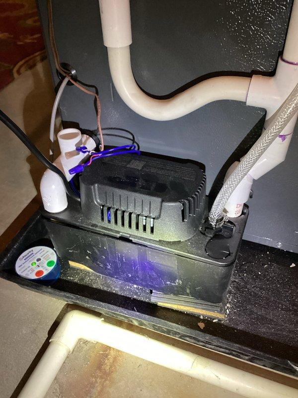 Diagnosed heat pump system failing to reach setpoint temperature. Installed new condensate pump with proper electrical connections and PVC drain line configuration. System now heating properly and maintaining temperature as designed.