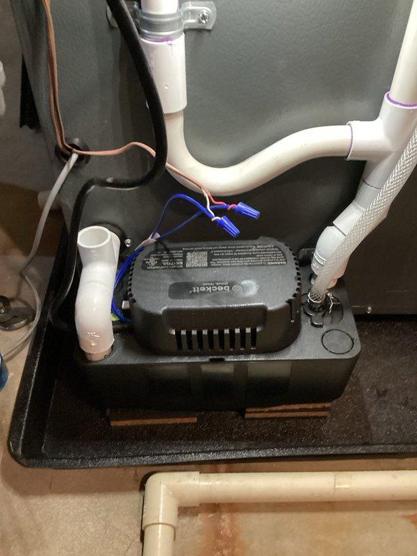 Diagnosed heat pump system failing to reach setpoint temperature. Installed new condensate pump with proper electrical connections and PVC drain line configuration. System now heating properly and maintaining temperature as designed.