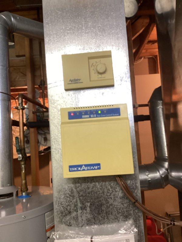 Responded to no-heat call for 10-year-old EnergiAir system (2011 model). Inspected HVAC installation including ductwork, damper mechanisms, and zone control system. Identified issue with Isolatemp CT-2 zone controller not properly communicating with Aprilaire thermostat, preventing furnace activation. Recalibrated control settings to restore proper heating function.