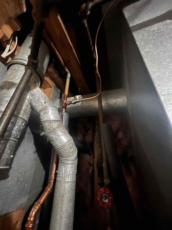 Successfully installed an Aprilaire whole-home humidifier in the utility area, connecting it to the existing water supply with new copper piping and a dedicated shutoff valve. Properly mounted the unit to the wall adjacent to insulated wall cavity, with all plumbing connections secured and tested for proper operation.