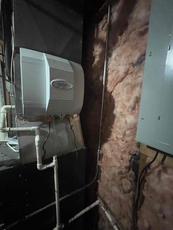 Successfully installed an Aprilaire whole-home humidifier in the utility area, connecting it to the existing water supply with new copper piping and a dedicated shutoff valve. Properly mounted the unit to the wall adjacent to insulated wall cavity, with all plumbing connections secured and tested for proper operation.