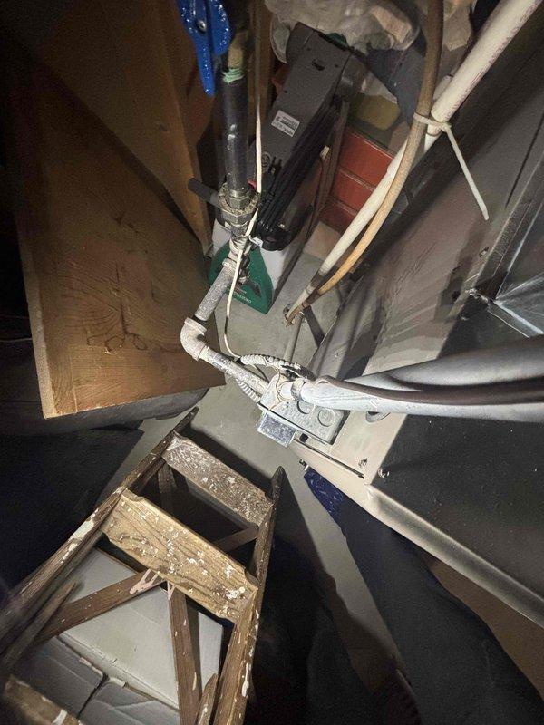 Conducted a water heater estimate in cramped utility area with visible electrical panel and deteriorated wooden components. Inspected existing electrical infrastructure including breaker panel and associated wiring. Documented conditions with photos for comprehensive assessment of installation requirements under CWOW reference 616-558-6379, CM 2017.